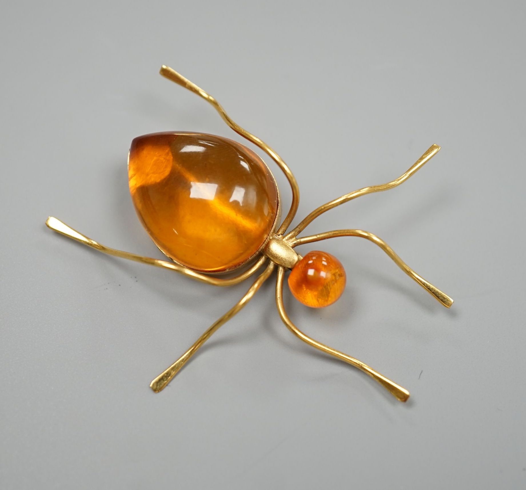 A yellow metal and two stone amber bead set bug brooch, 53mm, gross weight 5.6 grams.